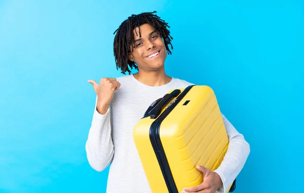 Young African American Traveler Man Holding Suitcase Pointing Side Present — Stock Photo, Image