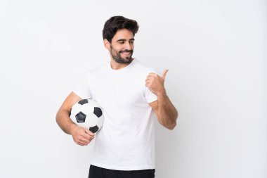 İzole edilmiş beyaz bir geçmişi olan sakallı yakışıklı genç bir adam bir ürün sunmak için kenarı işaret ediyor.