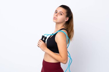 Teenager sport girl over isolated white background with jumping rope