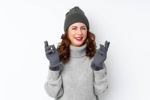 Young Russian woman with winter hat over isolated white background laughing