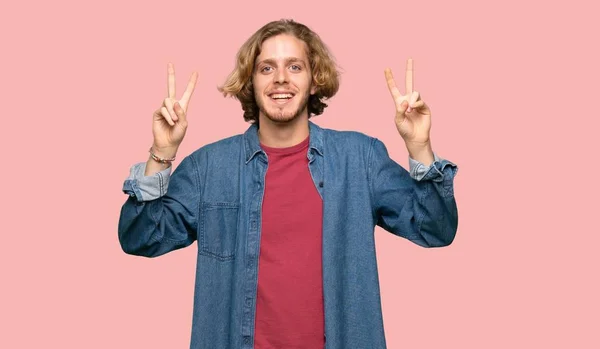 Blonde Man Showing Victory Sign Both Hands Colorful Background — Stock Photo, Image