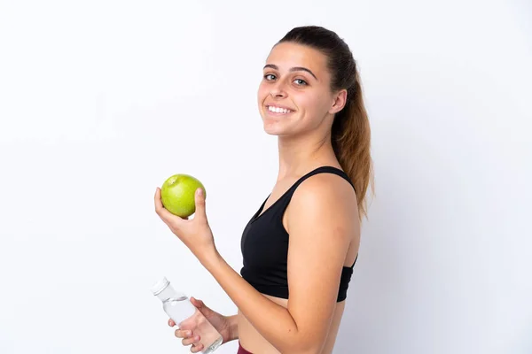 Egy tinédzser lány egy almával és egy üveg vízzel elszigetelve. — Stock Fotó