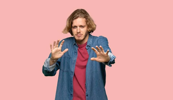 Blonde Man Nervous Stretching Hands Front Colorful Background — Stock Photo, Image