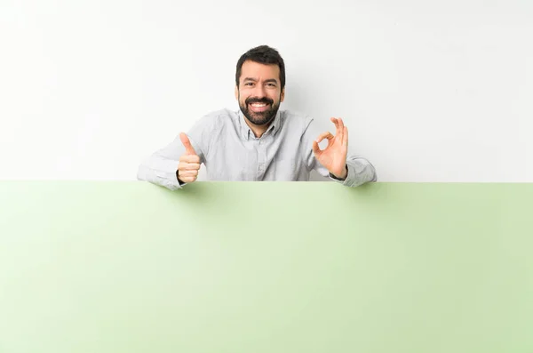 Young Handsome Man Beard Holding Big Green Empty Placard Showing — Stock Photo, Image