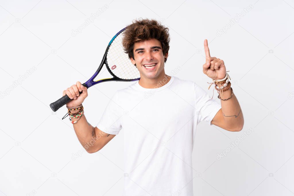 Young caucasian man over isolated white background playing tennis and pointing up