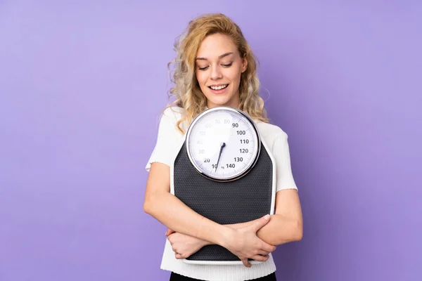 Giovane Donna Bionda Isolata Sfondo Viola Con Pesatrice — Foto Stock