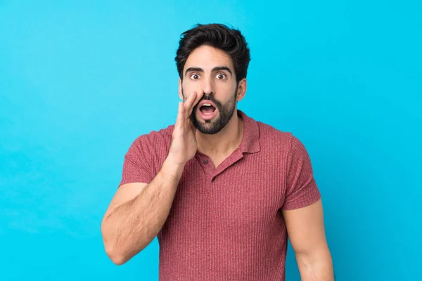 Joven Hombre Guapo Con Barba Sobre Fondo Azul Aislado Con —  Fotos de Stock