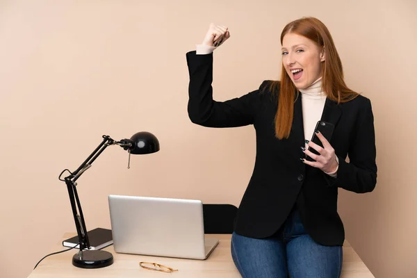 Business woman in a office making strong gesture