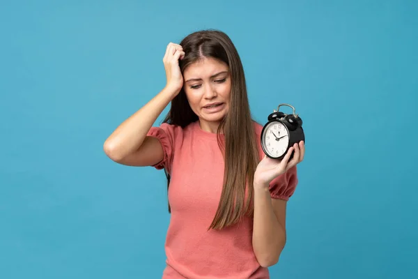 Young Woman Isolated Blue Background Holding Vintage Alarm Clock — 图库照片