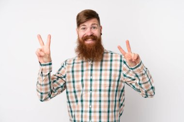 Uzun sakallı kızıl saçlı adam izole edilmiş beyaz arka planda iki eliyle zafer işareti gösteriyor.