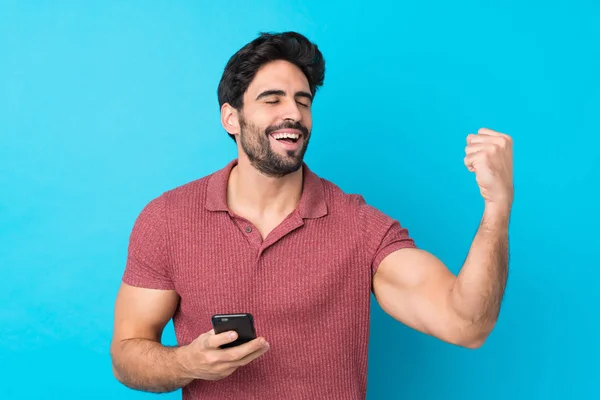 Joven Hombre Guapo Con Barba Sobre Fondo Azul Aislado Con —  Fotos de Stock