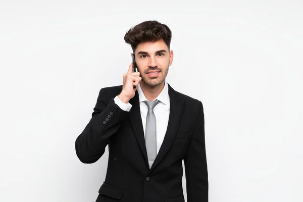 Jovem empresário com telefone celular sobre fundo branco isolado — Fotografia de Stock