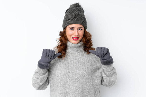 Young Russian woman with winter hat over isolated white background proud and self-satisfied