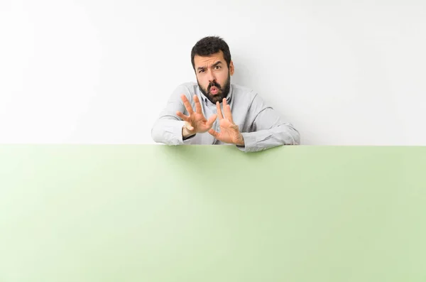 Young Handsome Man Beard Holding Big Green Empty Placard Nervous — Stock Photo, Image