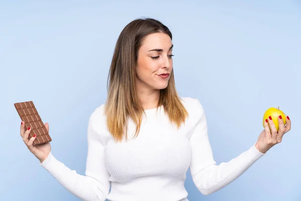 Junge Blonde Frau Auf Isoliertem Blauem Hintergrund Mit Zweifeln Während — Stockfoto