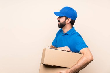 Yalıtılmış arka planda sakallı teslimatçı.