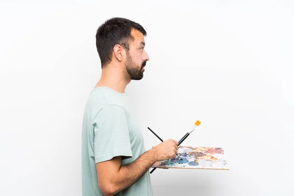 Joven Artista Sosteniendo Una Paleta Sobre Fondo Aislado —  Fotos de Stock