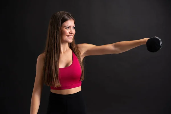 Mujer Deportiva Joven Haciendo Levantamiento Pesas Sobre Fondo Negro Aislado —  Fotos de Stock