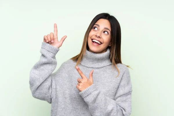 Woman Wearing Sweater Isolated Green Background Pointing Index Finger Great — Stock Photo, Image