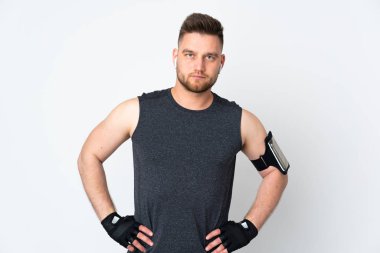 Beyaz arka planda izole edilmiş Rus sporcu kolları kalçasında poz veriyor.