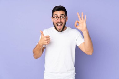 Kafkas yakışıklı adam izole edilmiş arka planda tamam işareti ve baş parmak hareketi gösteriyor