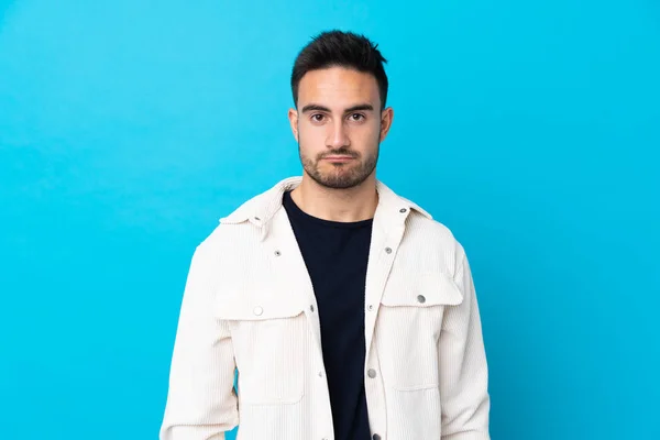 Joven Hombre Guapo Sobre Aislado Azul Fondo Triste — Foto de Stock