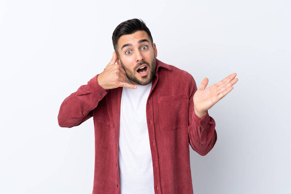 Young handsome man with beard wearing a corduroy jacket over isolated white background making phone gesture and doubting