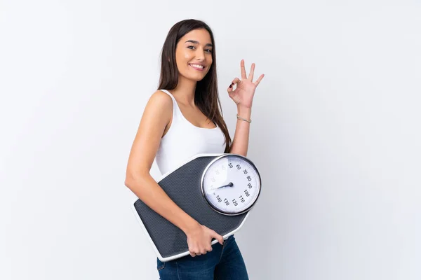 Young Brunette Woman Isolated White Background Holding Weighing Machine Doing — Stock Photo, Image