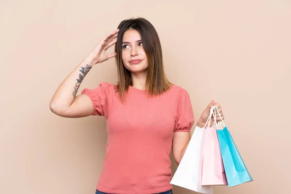 Young Woman Shopping Bag Isolated Background Having Doubts Confuse Face — Stock Photo, Image