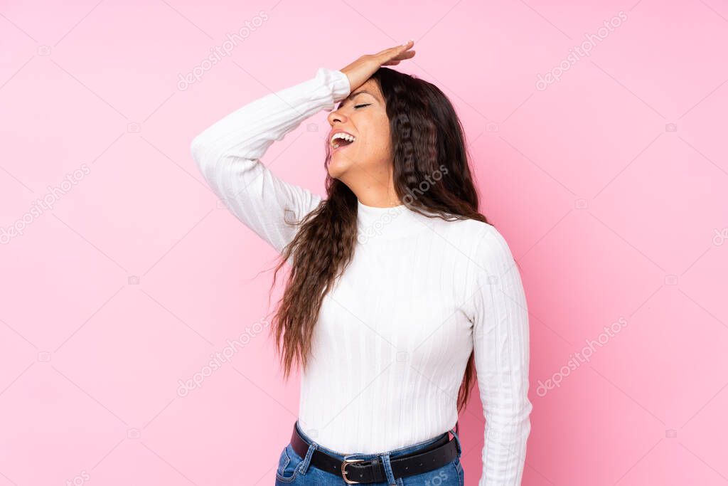 Young woman over isolated pink background has realized something and intending the solution