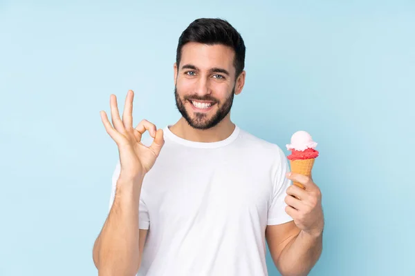 파란색 배경에 아이스크림을 손가락으로 오케이 사인을 표시하는 — 스톡 사진