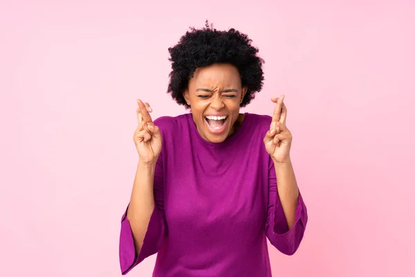 African American Woman Isolated Pink Background Fingers Crossing — стокове фото