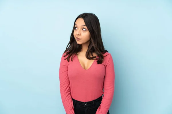 Young Mixed Race Woman Isolated Blue Background Making Doubts Gesture — Stock Photo, Image
