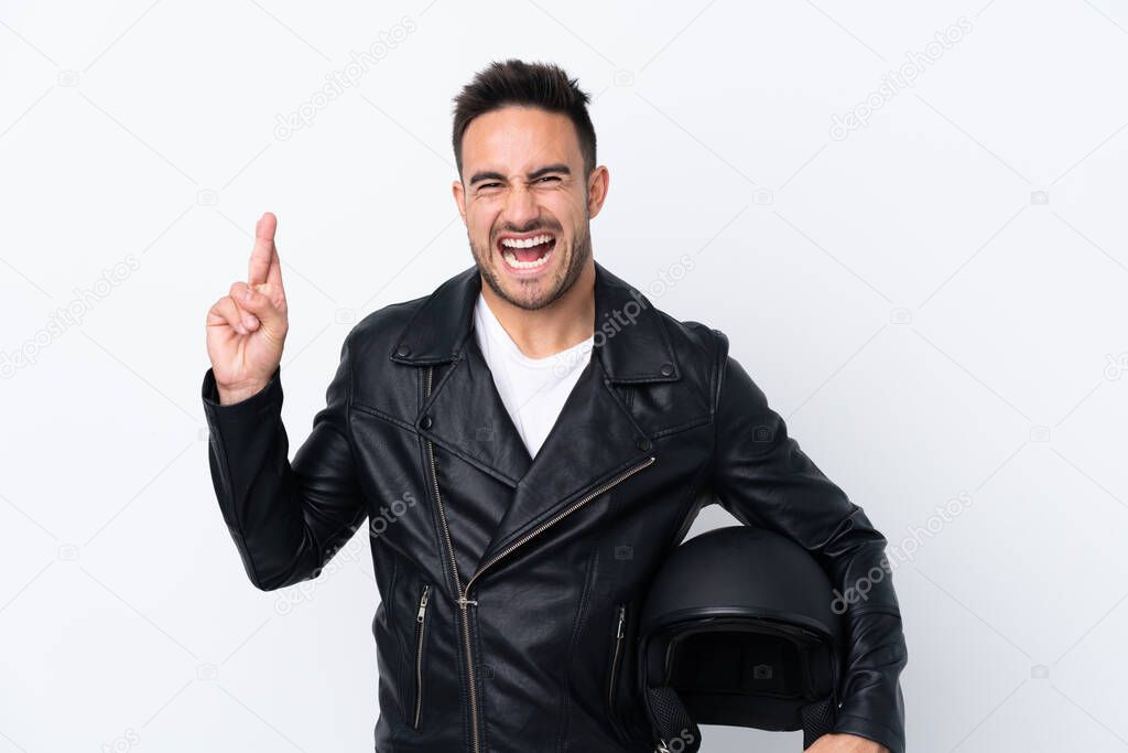 Man with a motorcycle helmet with fingers crossing