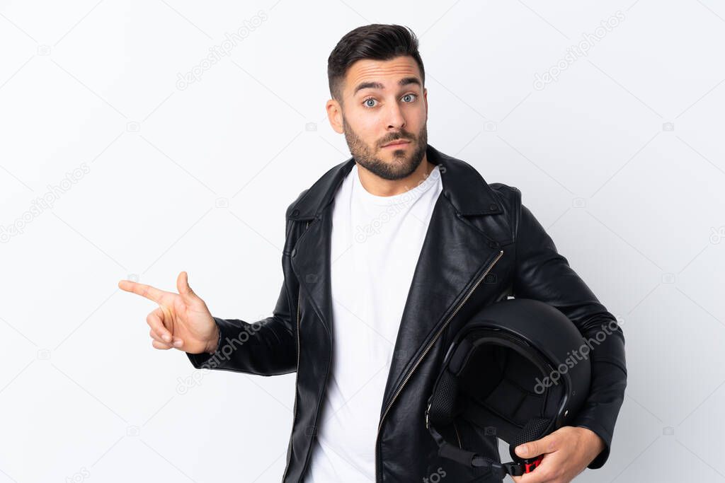 Man with a motorcycle helmet pointing to the laterals having doubts