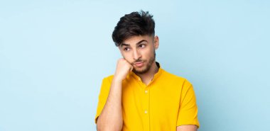 Yorgun ve sıkılmış ifadesiyle soyutlanmış Arap yakışıklı bir adam.