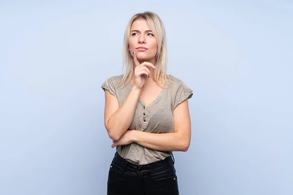 stock image Young blonde woman over isolated blue background thinking an idea