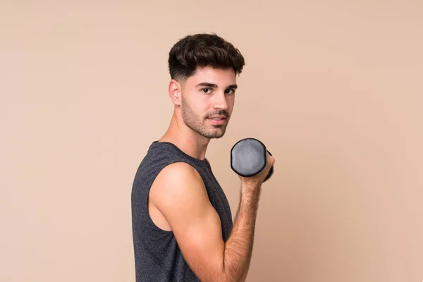 Joven Deportista Sobre Fondo Aislado Haciendo Levantamiento Pesas —  Fotos de Stock