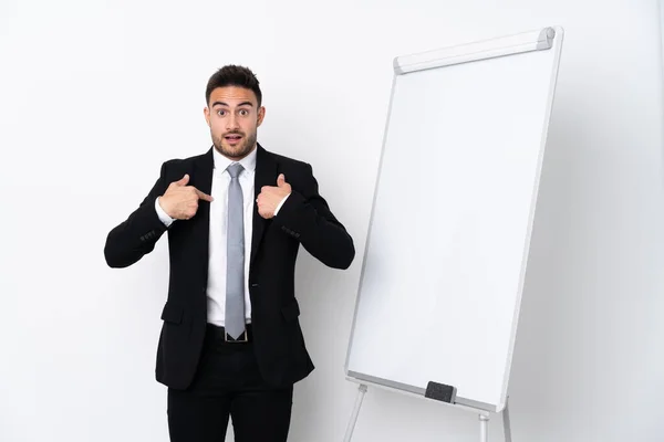 Young man giving a presentation on white board and with surprise expression