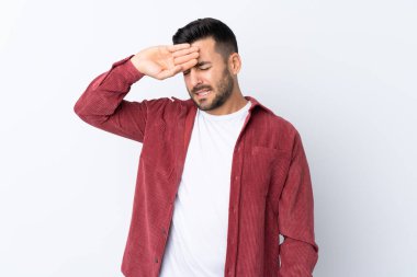 Sakallı, kadife ceket giyen genç yakışıklı bir adam izole edilmiş beyaz bir arka plan ve yorgun ve hasta bir yüz ifadesi var.