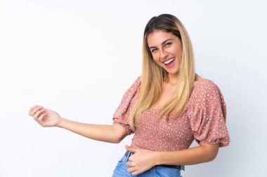 Genç Uruguaylı kadın izole edilmiş beyaz arka planda gitar hareketi yapıyor.