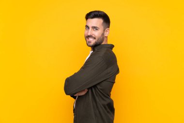 İzole edilmiş sarı arka planda gülen adam