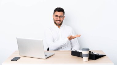 İş yerinde genç bir işadamı gülümseyerek bir fikir sunuyor.