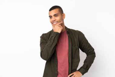 Genç Afro-Amerikan bir adam beyaz bir arka planda yan tarafa bakıyor.