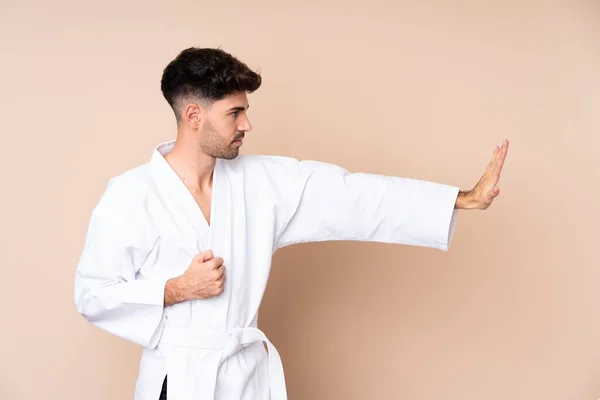 Joven Sobre Aislado Fondo Haciendo Karate —  Fotos de Stock