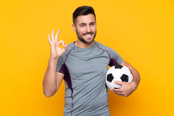 Man Isolated Yellow Background Soccer Ball Making Sign — Stock Photo, Image