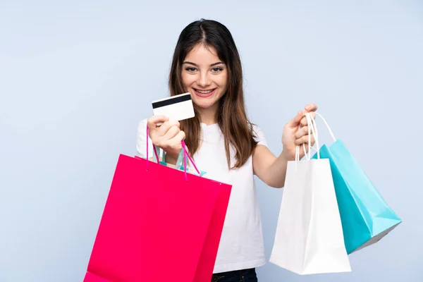 Jonge Brunette Vrouw Geïsoleerde Blauwe Achtergrond Holding Shopping Tassen Verrast — Stockfoto