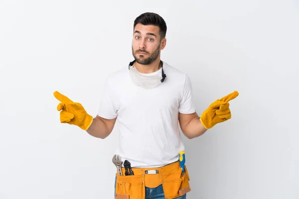Craftsmen Electrician Man Isolated White Background Pointing Laterals Having Doubts — Stock Photo, Image