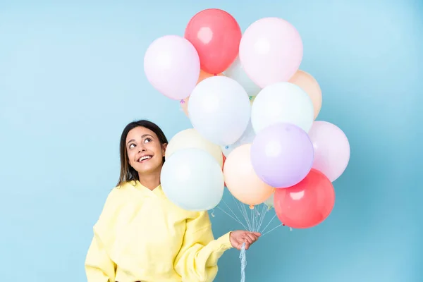 Woman Holding Balloons Party Isolated Blue Background Laughing Looking — Stock Photo, Image