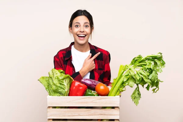 Farmer Woman Holding Fresh Vegetables Wooden Basket Pointing Finger Side — Stock Photo, Image